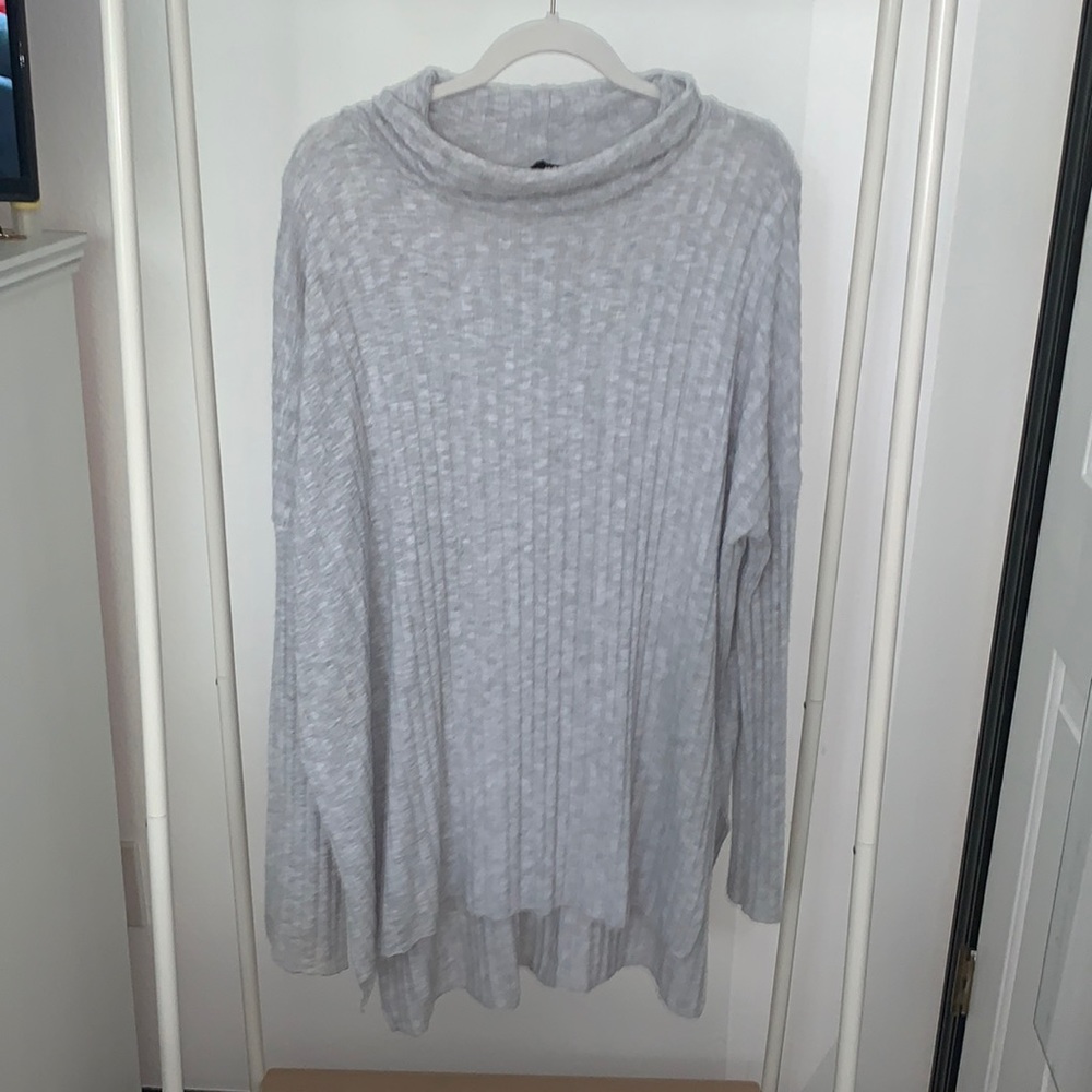 Out from under gray sweater